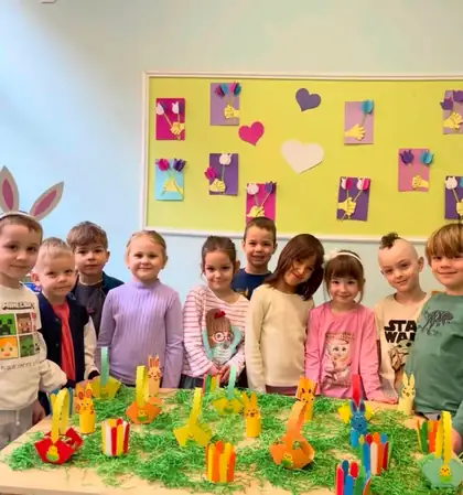 Children posing behind a table of Easter bunnies they made